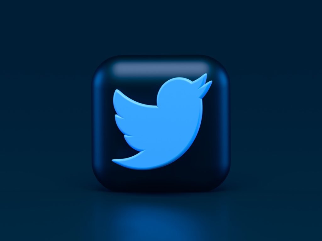 Twitter logo on black 3D button, dark background